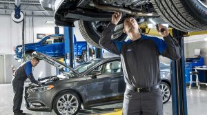 Ford technicians servicing vehicles in a modern auto repair shop